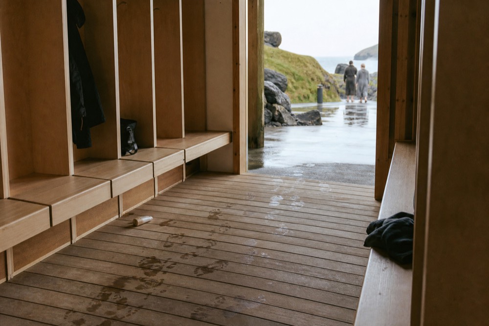 Empty wooden changing benches and lockers in a spa changing room