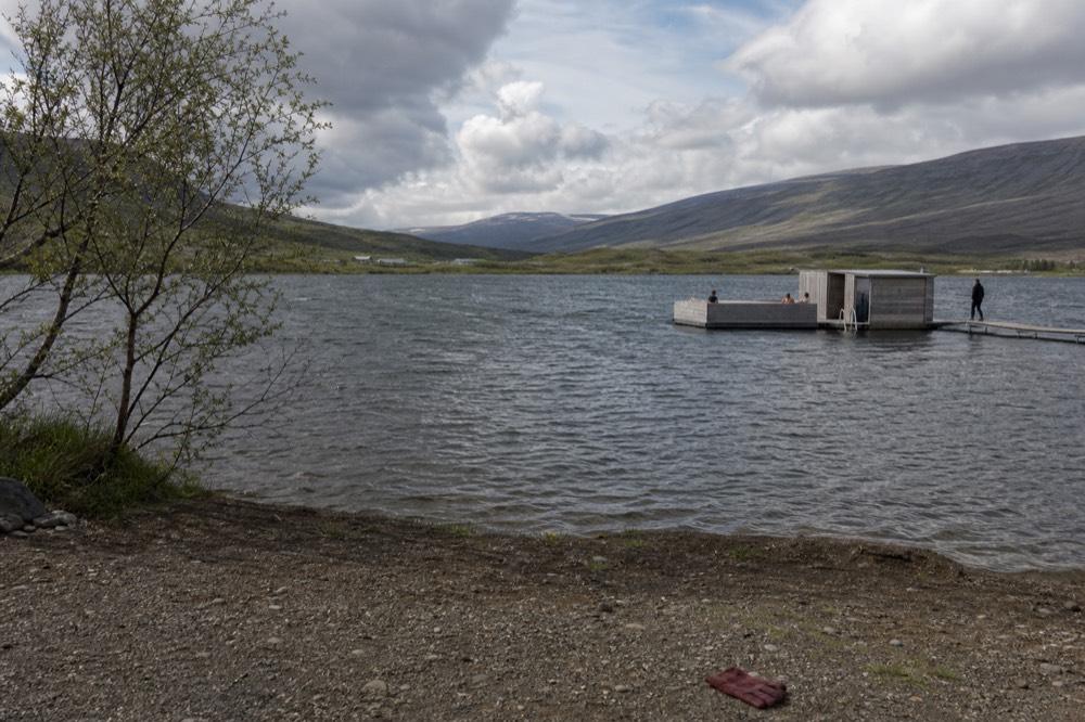 View across a lake toward distant mountains in the Eastfjords region