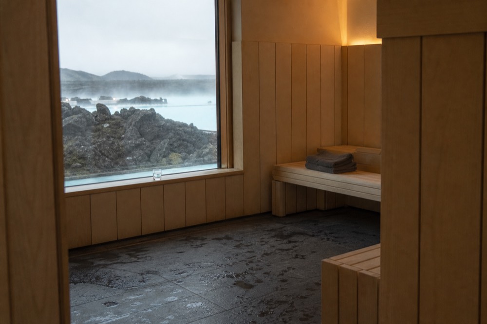 A private changing suite with wooden benches, soft lighting and folded towels